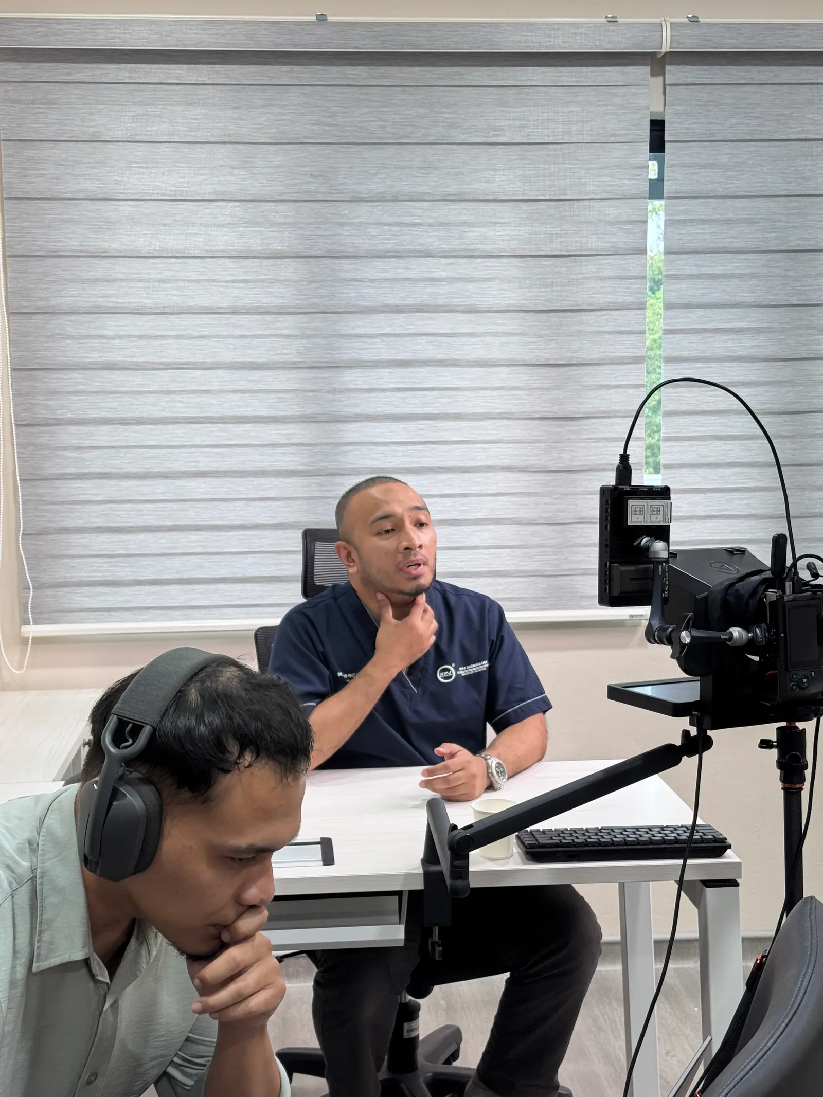 Dr. Muhd Faiz Zulkifli recording educational content during a Specialist House shoot